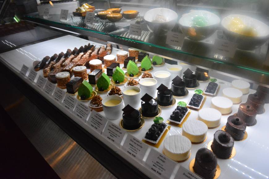 Patisserie Ravi,e Relier The lineup: Cakes and sweets in rows under the counter. | J.J. O'DONOGHUE