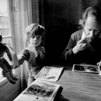 Long look: Photographer Sebastiao Salgado (right), the subject of his son (left) Juliano Salgado\'s documentary \"The Salt of the Earth,\" sorts through his images in the late 1970s. | &#169; SEBASTIãO SALGADO  &#169; DONATA WENDERS  &#169; SARA RANGEL  &#169; JULIANO RIBEIRO SALGADO