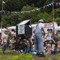 Fuji rocked: Children watch a performer in the kids\' section of the Fuji Rock Festival. | JAMES HADFIELD