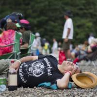 Fuji rocked: A music fan takes a break at Fuji Rock Festival at the Naeba Ski Resort in Niigata Prefecture. | JAMES HADFIELD