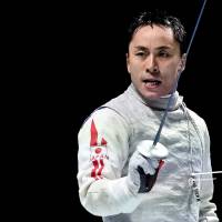 Yuki Ota reacts after winning the gold medal in the men\'s foil event on Thursday at the 2015 World Fencing Championships in Moscow. | AFP-JIJI