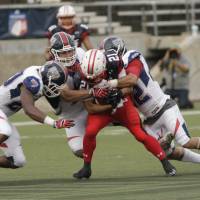 Japan running back Ryo Takagi is tackled by U.S. defenders during Saturday\'s gold medal game in Canton, Ohio. The U.S. won 59-12. | USA FOOTBALL / ED HALL JR.