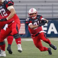 Japan running back Ryo Takagi carries the ball during Sunday\'s game against the United States at the IFAF world championship in Canton, Ohio. The U.S. won 43-18. | JAPAN AMERICAN FOOTBALL ASSOCIATION
