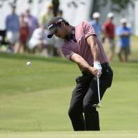 Jason Day chips onto the eighth green during the final day of the Canadian Open in Oakville, Ontario, on Sunday. Day rallies to win Canadian Open