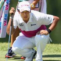 Hideki Matsuyama lines up a putt at the Fukushima Open on Sunday. | KYODO
