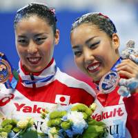 Yukiko Inui (left) and Risako Mitsui display their bronze medals from the synchronized swimming duet technical final at the FINA World Aquatics  Championships on Sunday in Kazan, Russia. | REUTERS