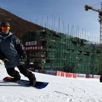 A man snowboards at the Yunding Ski Field, one of the proposed venues for Alpine skiing if Beijing wins the bid to host the 2022 Winter Games. Beijing confident in 2022 Games bid
