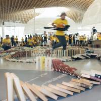During an event in the city of Gifu on Sunday to set a Guinness World Record, 10,148 books forming a line 1 km long are toppled like dominoes. A total of 9,862 of the books fell down, breaking the previous record of 5,318 books set during a similar event in Britain. | KYODO