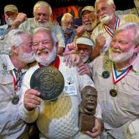 Charlie Boice (center) is congratulated by previous victors after winning the 2015 \"Papa\" Hemingway Look-Alike Contest at Sloppy Joe\'s Bar &#8212; a noted hangout of author Ernest Hemingway &#8212; in Key West, Florida, on Saturday. Boice won the annual contest on his 15th try, beating out 121 other entrants. The competition is a facet of the island\'s annual Hemingway Days festival. | ANDY NEWMAN / FLORIDA KEYS NEWS BUREAU / REUTERS