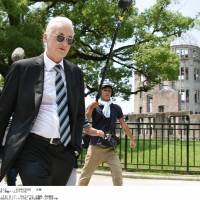 In his first visit to the city of Hiroshima since 1971, legendary Led Zeppelin guitarist Jimmy Page walks through Hiroshima Peace Memorial Park on Thursday. | KYODO