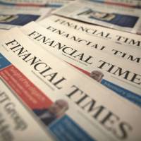 Copies of the Financial Times await delivery at a distribution center in London July 23. | BLOOMBERG