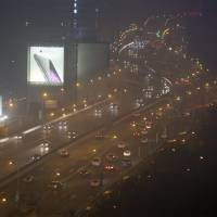 Cars drive on a highway on a hazy night in downtown Shanghai on Jan. 25. | REUTERS