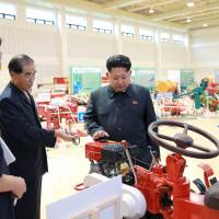 North Korean leader Kim Jong Un visits an exhibition of locally made farm machinery in this undated photo. | REUTERS