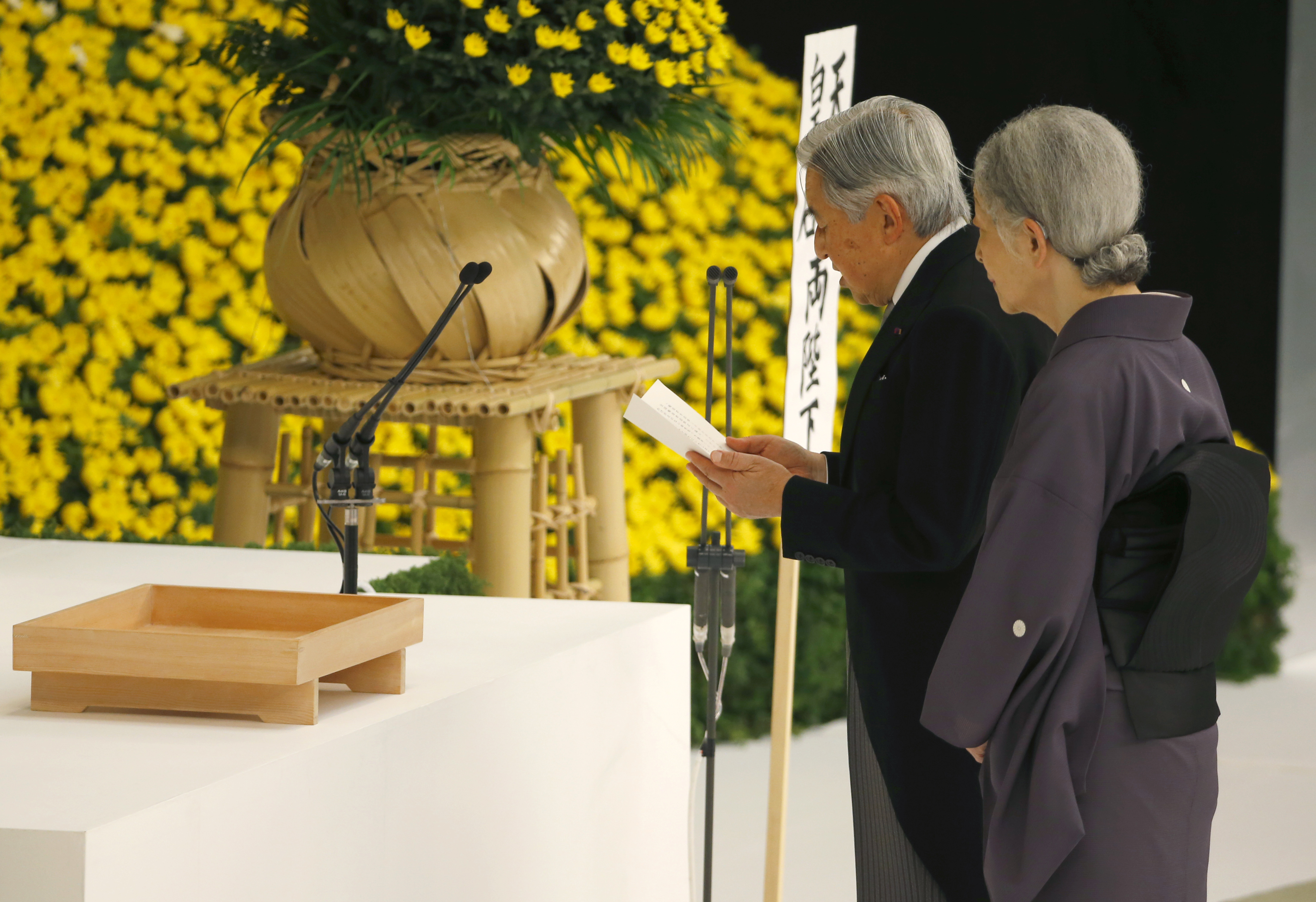 Emperor Akihito delivers his remarks with Empress Michiko during a memorial service at the Nippon Budokan hall in Tokyo on Saturday, the 70th anniversary of the end of World War II. | AP
