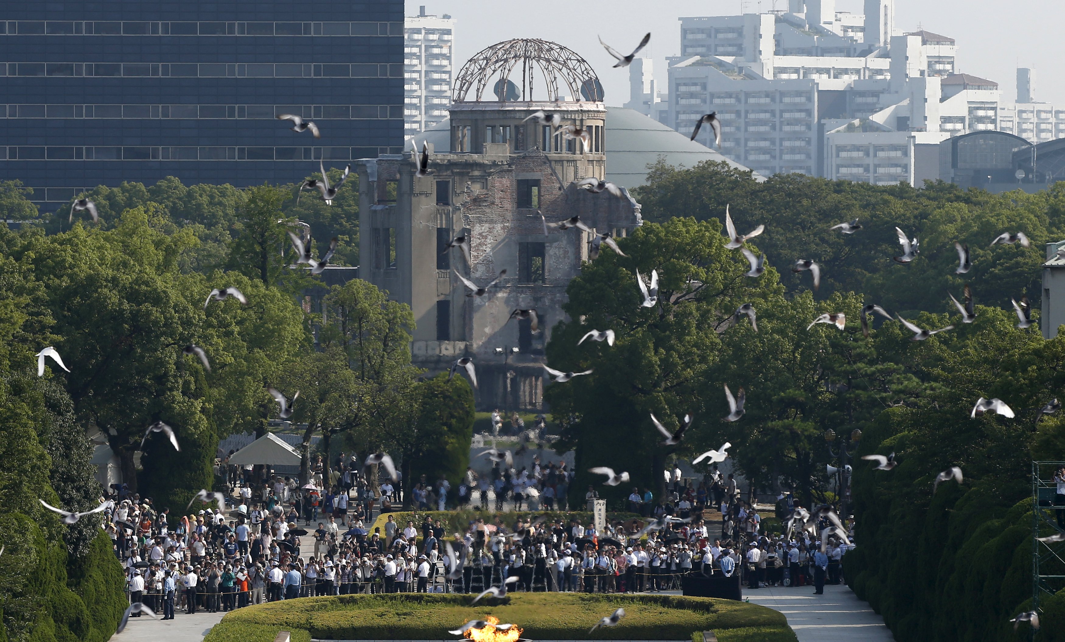Doves fly over Peace Memorial Park, with the Atomic Bomb Dome in the background, during the annual ceremony in Hiroshima on Thursday. | REUTERS