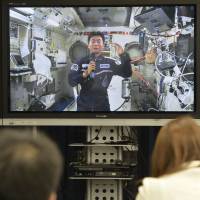Japanese astronaut Kimiya Yui speaks during a televised news conference from the International Space Station late Tuesday night. | KYODO