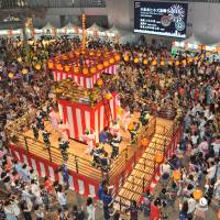 Visitors to the annual Roppongi Hills Bon Odori festival in central Tokyo on Saturday dance to traditional music. | KAZUAKI NAGATA