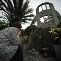 Kimie Mihara, a survivor of the Aug. 6, 1945, atomic bombing in Hiroshima prays at the cenotaph at the Atomic Bomb Dome in Hiroshima on July 3. | AP