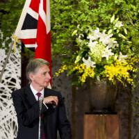 Foreign Minister Fumio Kishida and British Foreign Secretary Philip Hammond attend a news conference at Iikura House in Tokyo on Saturday. | REUTERS