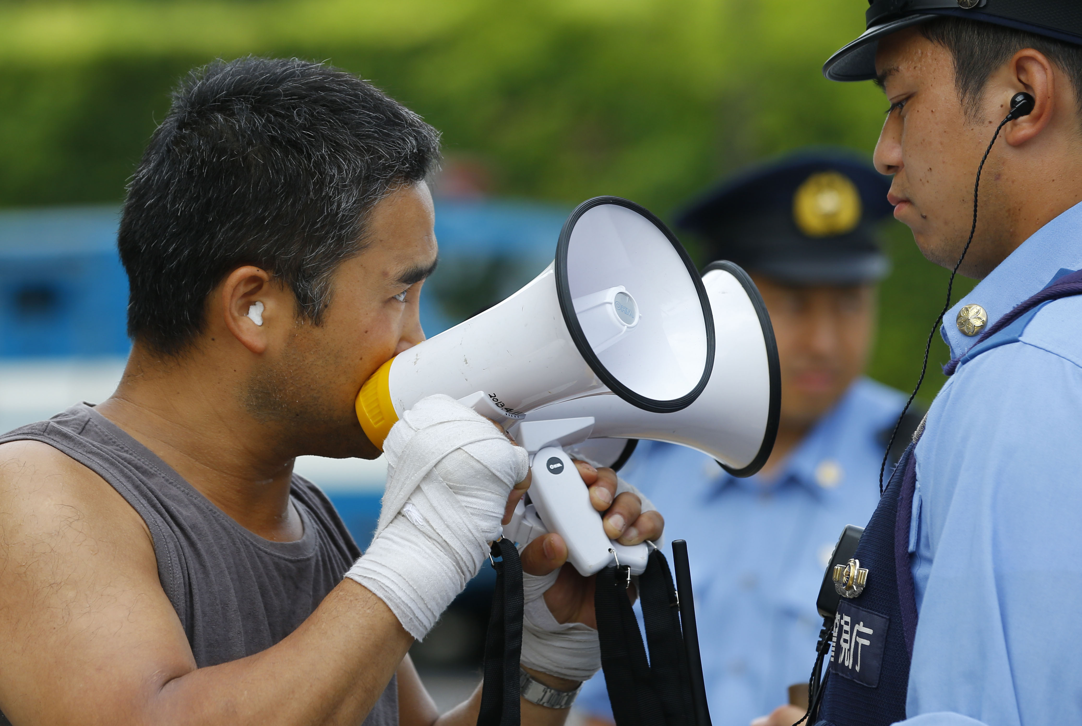 A protester uses a pair of megaphones to make his point during an anti-nuclear demonstration in Tokyo on Tuesday. | AP