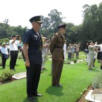 Group Capt. John Harwood (left), defense and armed services attache at the Australian Embassy in Tokyo, and Capt. Oliver Clark of the British Army, representing the British Embassy, attend the 21st annual memorial service in Yokohama on Saturday for POWs from the British Commonwealth and former Allied nations who died in Japan during World War II. | KAZUAKI NAGATA