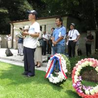 People attending the 21st memorial service held for POWs from the British Commonwealth and Allied nations who died in Japan during World War II sing at the event in Yokohama on Saturday. | KAZUAKI NAGATA
