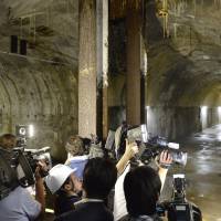 Members of the madia are allowed into a wartime underground vault below the Defense Ministry compound in Ichigaya, Tokyo, on Monday. | KYODO