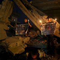 Young vigil: Palestinian children light candles to remember 18-month-old Ali Dawabsheh, who was killed after his home was allegedly set ablaze by Israeli extremists. Only a teenager, yet an expert on war