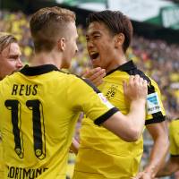Dortmund\'s Shinji Kagawa (right), seen in a file photo from earlier this month, scored in the German club\'s 4-3 win over Norwegian foe Odd on Thursday in a Europa League qualifier. | AFP-JIJI