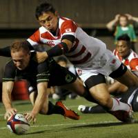 The World XV\'s Andrew Ellis is tackled by Japan\'s Ayumu Goromaru as he scores a try during Saturday\'s match at Prince Chichubu Memorial Ground. The World XV defeated the Brave Blossoms 45-20. | REUTERS