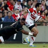 Japan\'s Kenki Fukuoka is tackled by the World XV\'s Taqele Naiyaravoro during Saturday\'s Rugby World Cup warmup match in Tokyo. | REUTERS