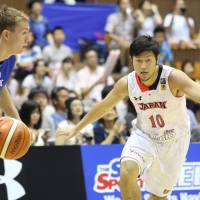 Japan guard Ryoma Hashimoto exhibits gritty defense against a Czech Republic player during Saturday\'s game at Yoyogi National Gymnasium Annex.  Japan beat the visitors 65-54. | KAZ NAGATSUKA