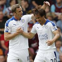Shinji Okazaki is congratulated by Leicester City teammate Andy King after scoring against West Ham United in the Premier League on Saturday. | AFP-JIJI