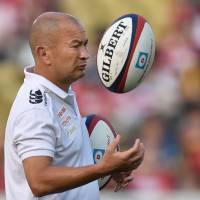 Japan coach Eddie Jones tosses a ball ahead of the Brave Blossoms\' game against the World XV in Tokyo on Saturday. | AFP-JIJI