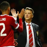 Manchester United manager Louis van Gaal celebrates with defender Chris Smalling after Tuesday\'s win over Bruges. | REUTERS