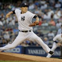 New York starting pitcher Masahiro Tanaka delivers during the first inning of the Yankees\' 7-3 defeat to the Indians on Friday. | AP