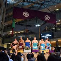 Sumo wrestlers wearing kesho mawashi ceremonial aprons take part in a pre-tournament ritual during an event held at a shopping complex in Tokyo\'s Chiyoda Ward on Saturday. | SATOKO KAWASAKI