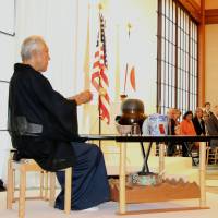 Sen Genshitsu, a grand tea master of the Urasenke school of tea, performs a tea ceremony to wish for Japan-U.S. friendship and world peace at the Japanese embassy in Washington on Tuesday. The ceremony was held to commemorate the 70th anniversary of the end of World War II. | KYODO