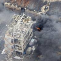 Black smoke and flames can be seen at Nippon Steel &amp; Sumikin Pipe Co.\'s idled plant in Kawasaki at around noon on Monday. The fire, which was subsequently put out, spread to chemical-maker Kao Corp.\'s adjacent factory and caused a section of a nearby expressway to be temporarily closed to traffic. | KYODO