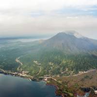 Mount Sakurajima, across the bay from the city of Kagoshima in Kagoshima Prefecture, is seen Saturday. The same day, the Meteorological Agency raised the alert level to 4 and urged nearby residents to be prepared to evacuate, as the volcano is showing signs of increased activity. | KYODO