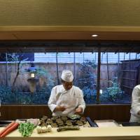 Yoshihiro Murata (center), master chef for Kikunoi Japanese restaurant and chairman of the Japanese Culinary Academy, works the kitchen with other chefs at the restaurant in a file photo taken in 2013. Murata, who holds seven Michelin stars across three establishments in Kyoto and Tokyo, plans to open a restaurant in London\'s Mayfair serving modern dishes based on traditional Japanese cuisine. | BLOOMBERG