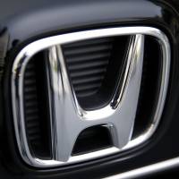 A Honda Motor Co. badge from a N-One minicar is displayed in a showroom at the company\'s headquarters in Tokyo. The automaker said Tuesday North American production has reached 30 million automobiles since 1982. | BLOOMBERG