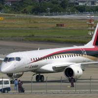 A Mitsubishi Regional Jet (MRJ) passenger aircraft, developed by Mitsubishi Aircraft Corp., taxies during a low speed taxiing test at Nagoya airport in Aichi Prefecture on June 10. | BLOOMBERG