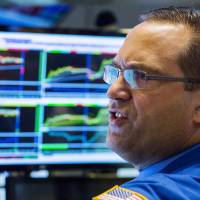 A trader works on the floor of the New York Stock Exchange shortly after the market opened in New York Tuesday. Continued concerns over China\'s economy sent shares falling anew. | REUTERS