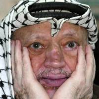 A file picture taken in 2003 shows Palestinian leader Yasser Arafat holding up a map of the controversial Israeli \"security\" fence during a meeting with a French solidarity delegation in the West Bank city of Ramallah. Arafat died in Percy military hospital near Paris aged 75 in November 2004 after developing stomach pains while at his headquarters in the West Bank city of Ramallah. His widow, Suha, has maintained he was poisoned, possibly by highly radioactive polonium. But the judges ruled there was \"not sufficient evidence of an intervention by a third party who could have attempted to take his life,\" the prosecutor said. | AFP-JIJI