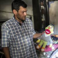 Abdullah Kurdi, father of Aylan Kurdi, a 3-year-old boy who drowned off Turkish coast, stands in Aylan\'s room on Sept. 6 in Kobani, Syria. | AFP-JIJI