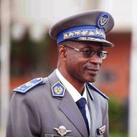 Burkina Faso junta leader Gen. Gilbert Diendere waits for Senegalese President Macky Sall to arrive at the airport for talks in Ouagadougou on Friday. | AP