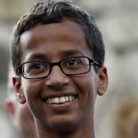 This Sept. 16 file photo shows 14-year-old Ahmed Ahmed Mohamed as he speaks during a news conference in Irving, Texas. The Muslim teenager who became an overnight sensation after a Texas teacher mistook his homemade clock for a bomb has been withdrawn from his school, local media reported Tuesday. Ahmed Mohamed, 14, won invitations to the White House, Google and Facebook last week amid a surge of public support for the aspiring inventor who was taken away from school in handcuffs. \"Cool clock, Ahmed. Want to bring it to the White House? We should inspire more kids like you to like science. It\'s what makes America great,\" Obama tweeted hours after the story broke. | BEN TORRES / GETTY IMAGES / AFP-JIJI