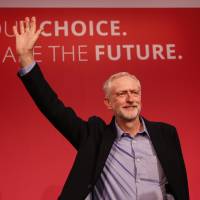 Jeremy Corbyn, the new leader of Britain\'s opposition Labour Party, waves after making his inaugural speech at the Queen Elizabeth Centre in London on Saturday. | REUTERS