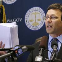 Washington Attorney General Bob Ferguson holds up what he said were 19 reports and studies done since 1992 of vapors escaping from tanks at the Hanford Nuclear Reservation, at a news conference, Wednesday in Seattle. Ferguson announced the filing of a lawsuit by his office against the U.S. Department of Energy and its contractor, Washington River Protection Solutions, alleging that hazardous tank vapors at the Hanford Nuclear Reservation pose serious risk to workers there. In June, Ferguson said he would oppose a U.S. Department of Energy request to have more time to empty the next group of waste storage tanks at Hanford. | AP